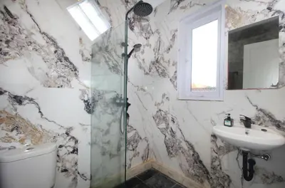 a bathroom with a shower and a sink at Zowa Villa Seminyak byFaba in Seminyak