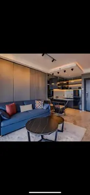a living room with a blue couch and a table at The Two Umalass in Canggu