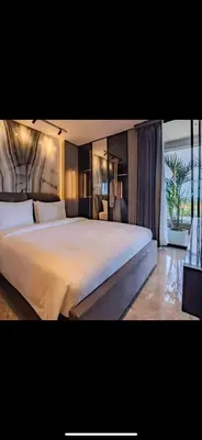 a bedroom with a large white bed in a room at The Two Umalass in Canggu
