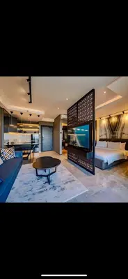 a large living room with a bed and a table at The Two Umalass in Canggu
