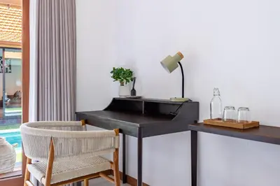 a black desk with a lamp and two chairs at Villa Marsin Umalas - 10 Minutes to Finns Beach Club in Seminyak