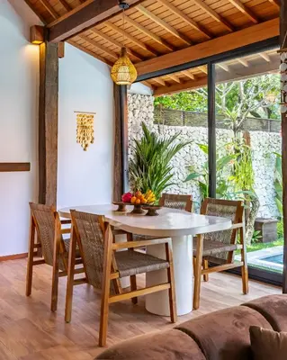 a dining room with a table and chairs at Villa Marsin Umalas - 10 Minutes to Finns Beach Club in Seminyak