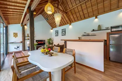 a kitchen and dining room with a white table and chairs at Villa Marsin Umalas - 10 Minutes to Finns Beach Club in Seminyak