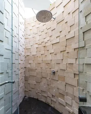 a bathroom with a shower with a glass door at Modern 2BR Villa with Private Pool Prime Location in Seminyak
