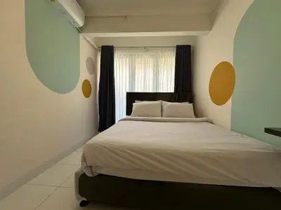 a bedroom with a large bed and a window at Rumah Jimbaran Kuta 2 bedroom 6 pax SukaBali 2 in Jimbaran