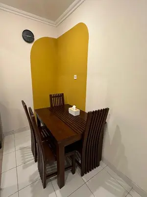 a dining room with a wooden table and chairs at Rumah Jimbaran Kuta 2 bedroom 6 pax SukaBali 2 in Jimbaran