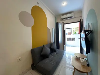 a living room with a couch and a table at Rumah Jimbaran Kuta 2 bedroom 6 pax SukaBali 2 in Jimbaran