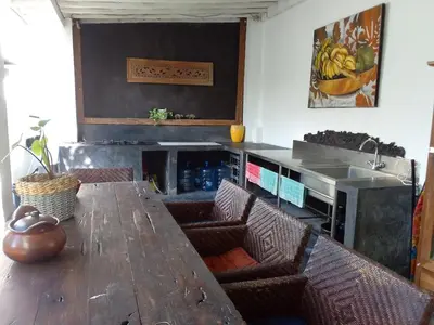 a dining room with a table and chairs and a fireplace at villa putih in Seminyak