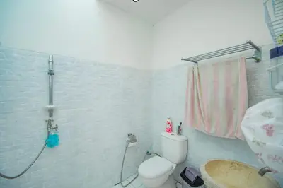 a bathroom with a shower and a toilet and a sink at villa putih in Seminyak