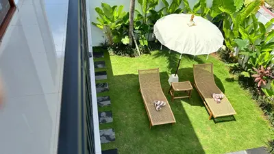 an overhead view of a patio with two chairs and an umbrella at Villa Bumbabu in Kerobokan