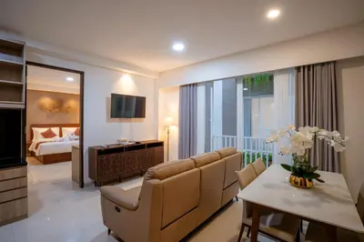 a living room with a couch and a dining room at Grand Inkuta in Seminyak