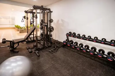 a gym with a row of exercise equipment at Grand Inkuta in Seminyak
