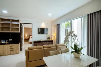 a living room with a couch and a table at Grand Inkuta in Seminyak