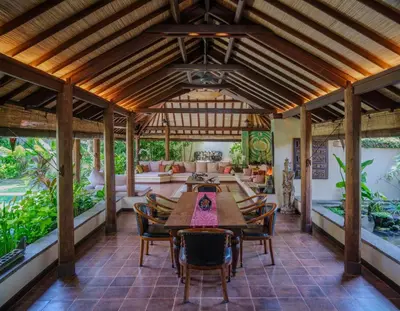 an outdoor dining room with a table and chairs at Villa Mata Budha Seminyak in Seminyak