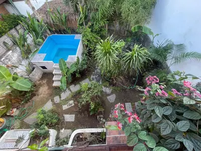 an overhead view of a garden with a swimming pool at 2BR Abelle garden lumbung house in Kerobokan