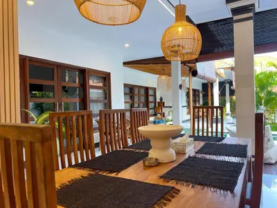 a dining room with a table with rugs on it at 4bedroom - Kamaya Villa in center of Seminyak in Seminyak