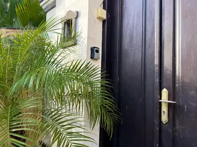 a black door with a palm plant next to it at 4bedroom - Kamaya Villa in center of Seminyak in Seminyak