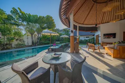 a patio with a table and chairs next to a pool at Villa Lea Luxury Oasis in Seminyak Umalas with private pool 4BR in Seminyak