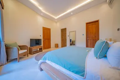 a large bedroom with a blue bed and a living room at Villa Lea Luxury Oasis in Seminyak Umalas with private pool 4BR in Seminyak