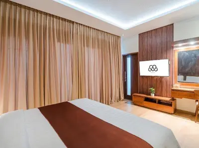 a bedroom with a large bed and a piano at Metta Villa in Jimbaran