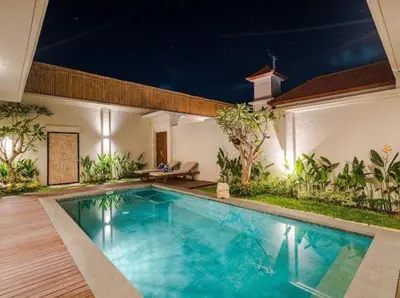 a swimming pool in the middle of a house at Metta Villa in Jimbaran