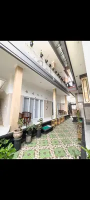 a large room with potted plants in a building at narayuka house kamar 3 in Seminyak