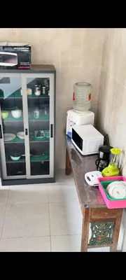 a counter in a kitchen with a microwave and a counter top at narayuka house kamar 3 in Seminyak