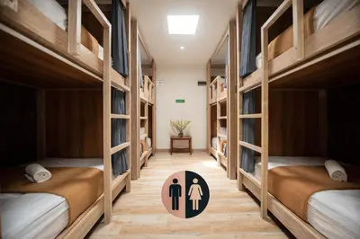 a room with four bunk beds with a sign in the middle at Pepitu Dormitory By Sandat in Kuta