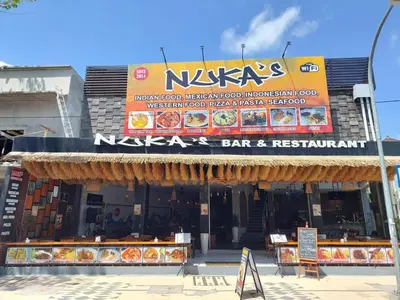 a restaurant with a sign in front of it at Pepitu Dormitory By Sandat in Kuta