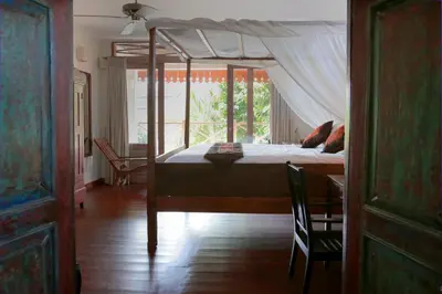 a bedroom with a bed with a canopy at Villa Varuna in Legian