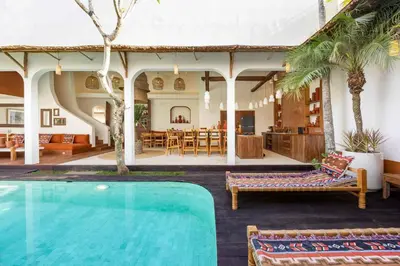 a house with a swimming pool and a living room at Villa Galanga - Brand New Ethnic Hacienda Villa Next to Canggu with Private Pool and Parking in Kerobokan