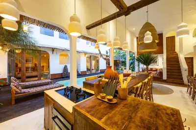 a kitchen and living room with a table and chairs at Villa Galanga - Brand New Ethnic Hacienda Villa Next to Canggu with Private Pool and Parking in Kerobokan