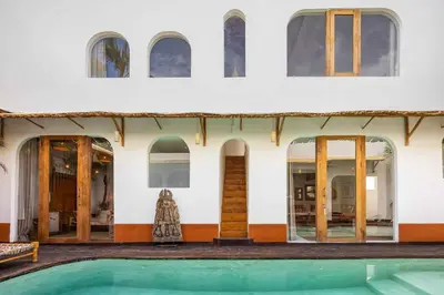 a house with a pool in front of it at Villa Galanga - Brand New Ethnic Hacienda Villa Next to Canggu with Private Pool and Parking in Kerobokan