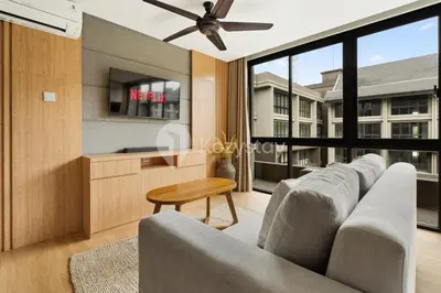 a living room with a couch and a ceiling fan at Palma by Kozystay - Nusa Dua in Nusa Dua