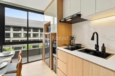 a kitchen with a sink and a large window at Palma by Kozystay - Nusa Dua in Nusa Dua