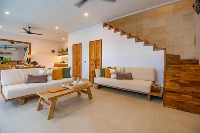 a living room with two couches and a table at Sister Suites in Seminyak