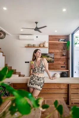 a woman in a dress standing in a kitchen at Sister Suites in Seminyak