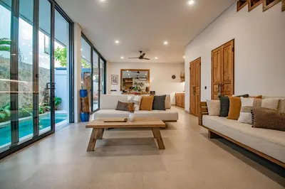 a living room with two couches and a table at Sister Suites in Seminyak