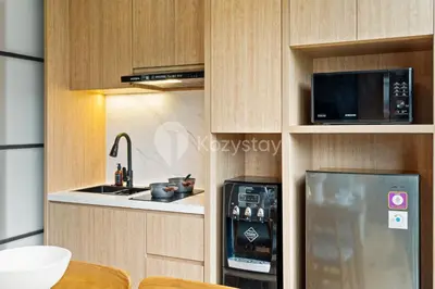 a kitchen with a refrigerator and a microwave at Olaia by Kozystay - Nusa Dua in Nusa Dua