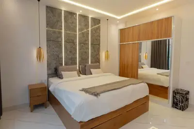 a bedroom with a large bed and a large mirror at Cozy Seminyak Loft 360 in Seminyak