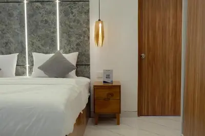 a bedroom with a bed and a nightstand with a bed sidx sidx at Cozy Seminyak Loft 360 in Seminyak
