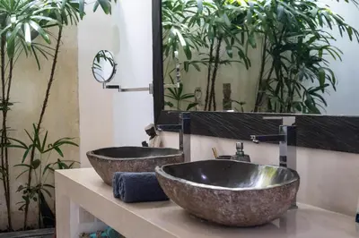 a bathroom with two sinks and a large mirror at Villa Minha Gente Seminyak in Seminyak