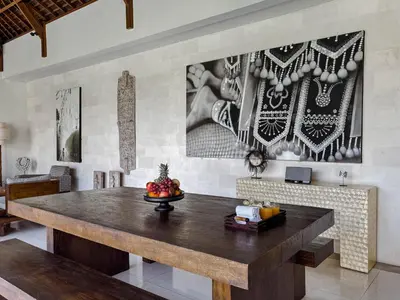 a dining room with a wooden table in a room at Villa Chocolat Seminyak 2 Bedroom in Seminyak