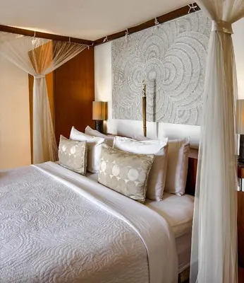 a bedroom with a large bed with white pillows at Villa Chocolat Seminyak 2 Bedroom in Seminyak