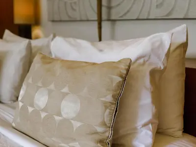 a group of pillows sitting on top of a bed at Villa Chocolat Seminyak 2 Bedroom in Seminyak