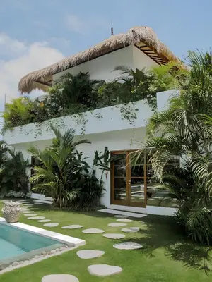 a villa with a swimming pool and a resort at Villa Chocolat Seminyak 6 Bedroom in Seminyak