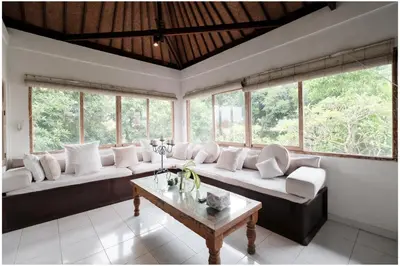 a living room with a couch and a table at Villa Hari in Seminyak