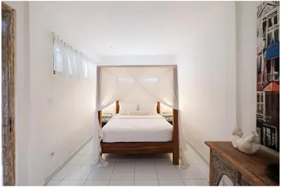 a bedroom with a bed with a canopy at Villa Hari in Seminyak