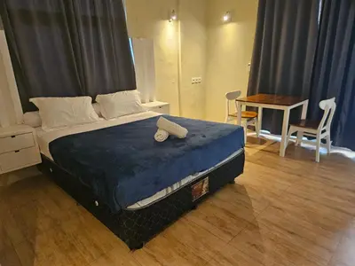 a bedroom with a bed with a blue comforter at Two Brothers Guesthouse in Legian