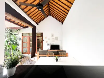 a living room with a wooden ceiling at Villa Sayang 2 in Seminyak